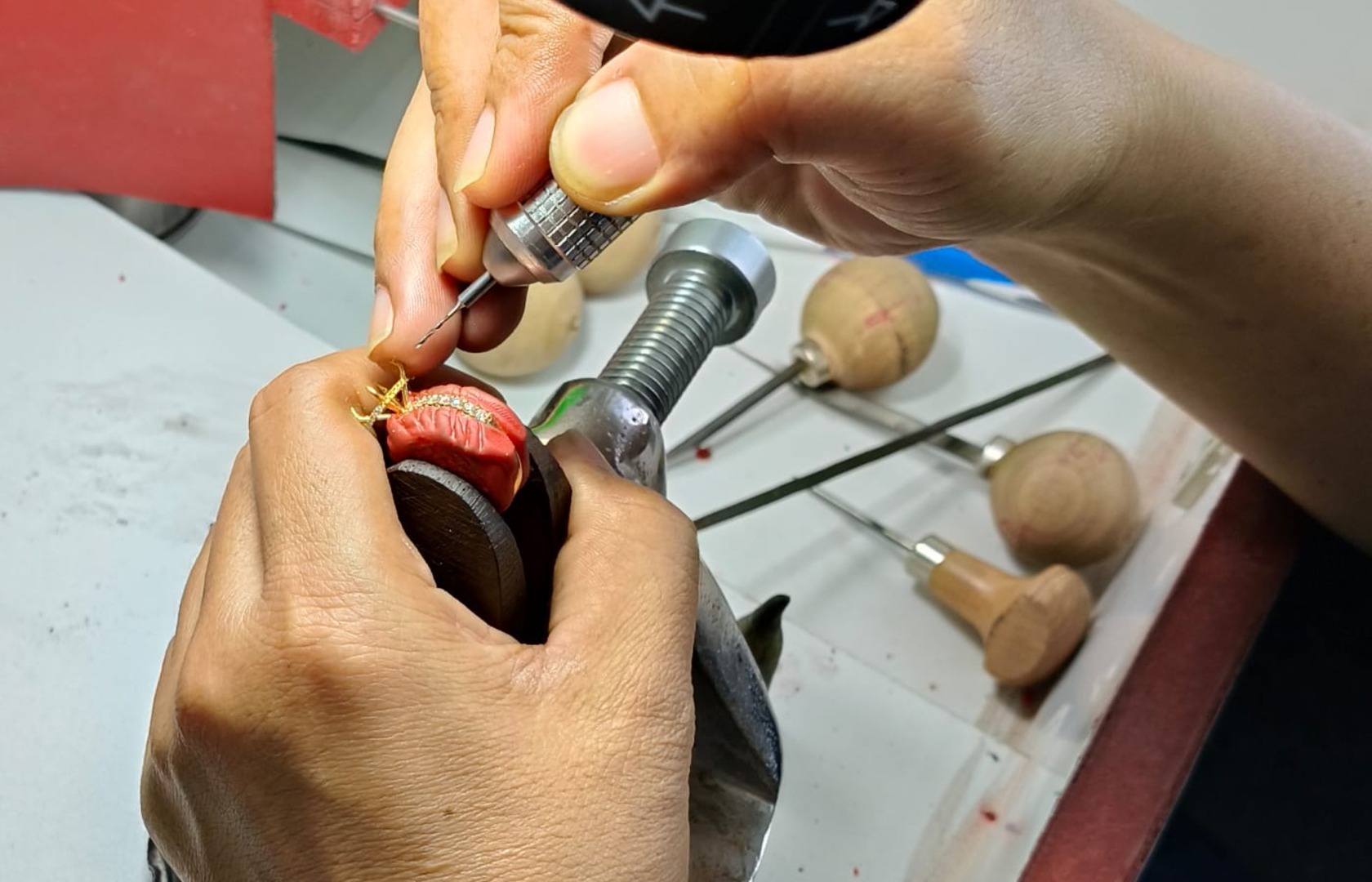 BCJExport craftsperson setting stones under magnification
