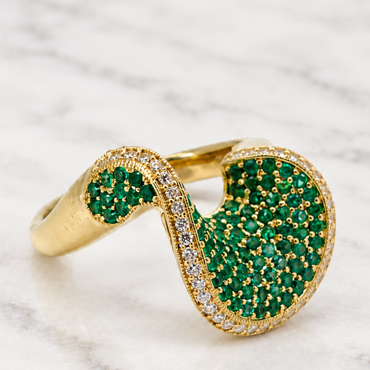 Gold ring with a green gemstone surface